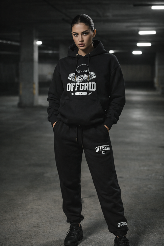 Woman wearing OFFGRID black hoodie and sweatpants in parking garage setting